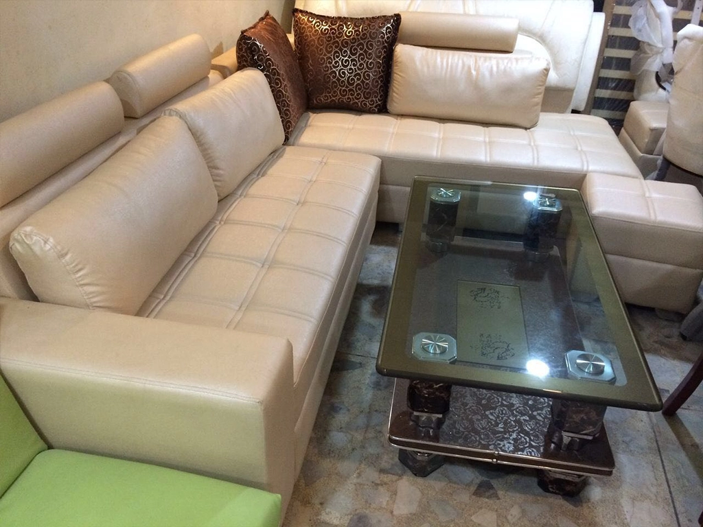 L shaped leatherette sofa set with brown color center table,