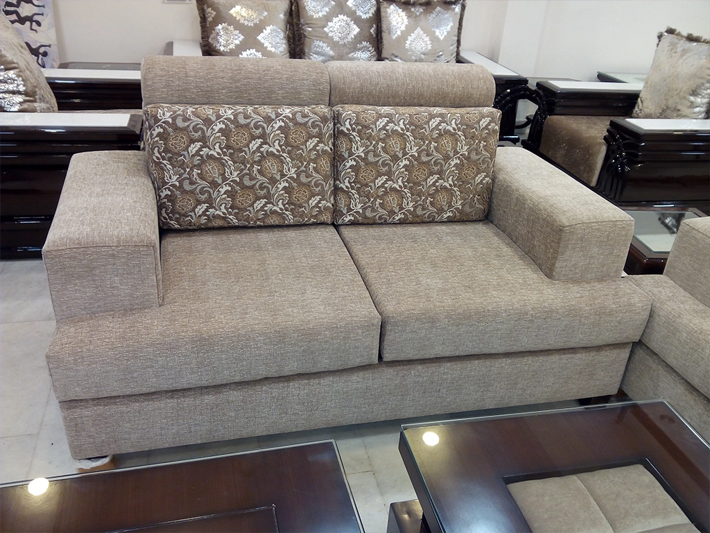 A two seater straight line sofa with fabric finish for hall area.