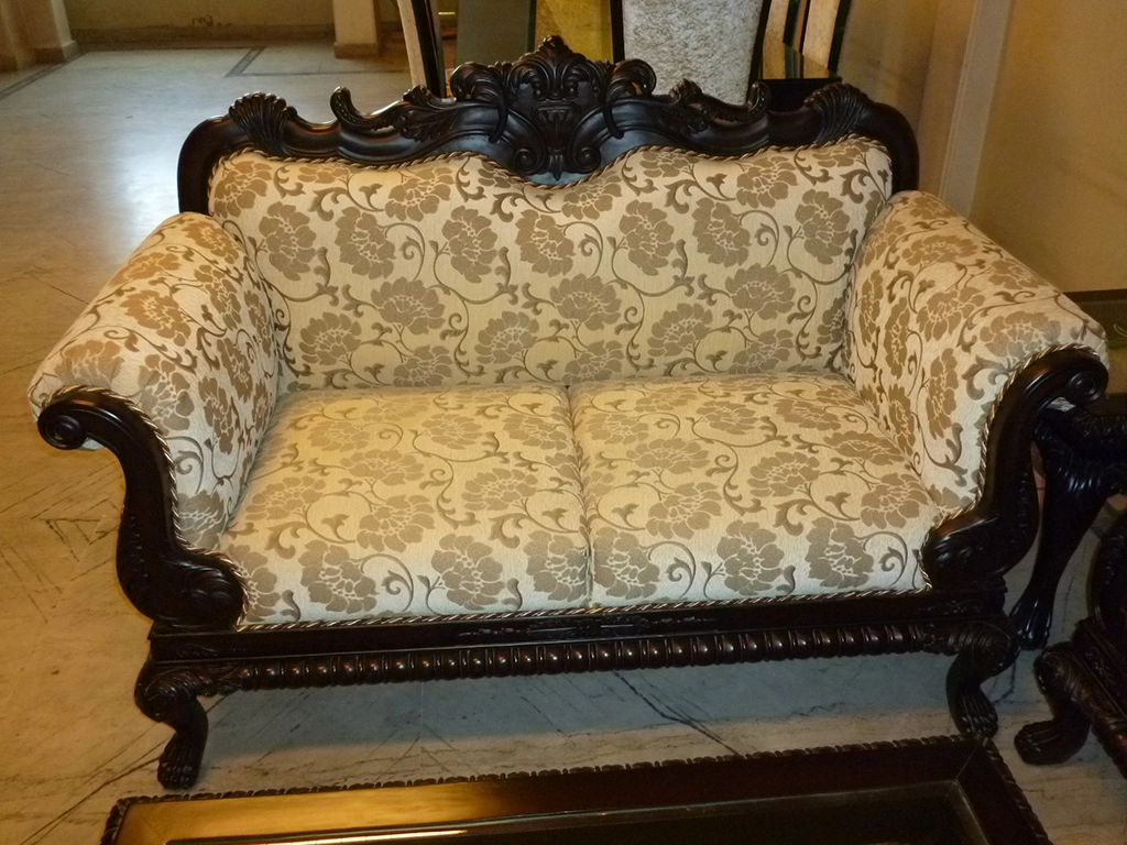 A two seater printed fabric carving sofa for living room.