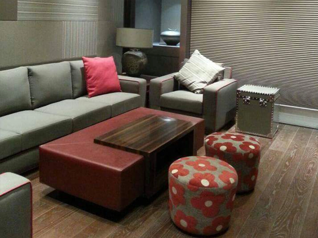 One Set L shaped Sofa set grey color, center table and two pouffe.