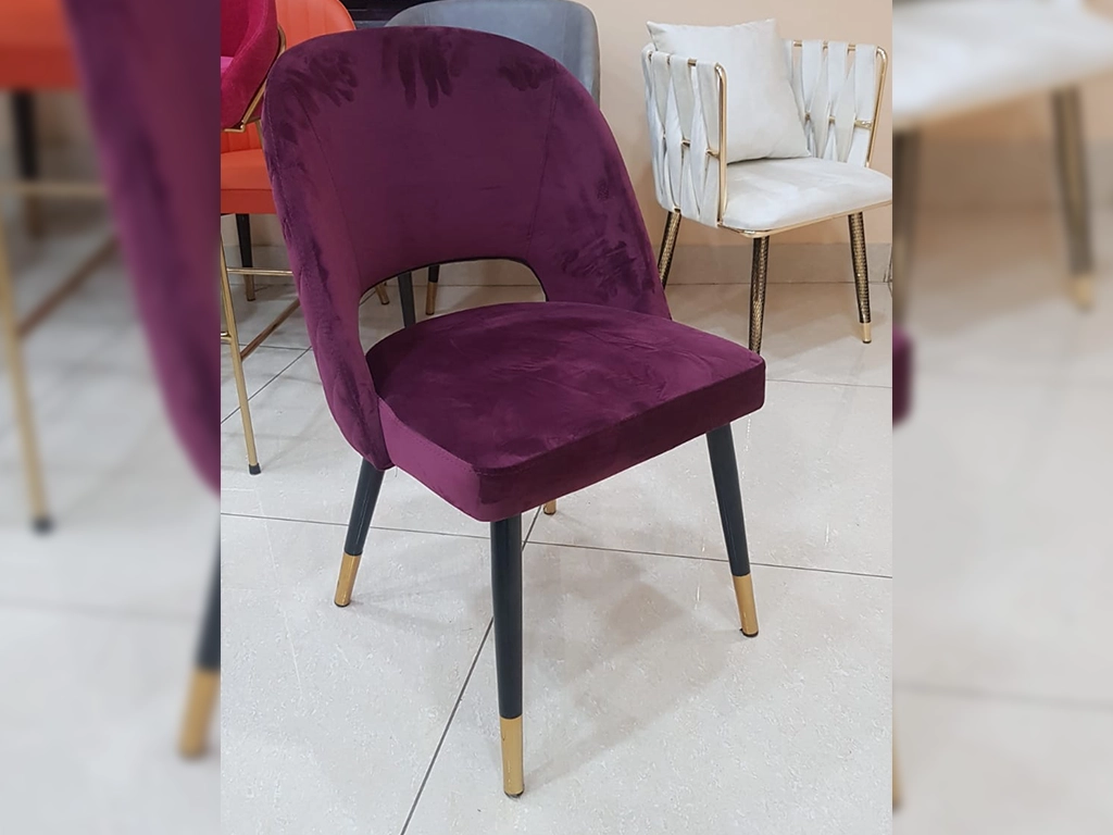 Maroon color Chair With velvet upholstered back and seat, back round edges, metal black powder coated with gold cap finish legs.