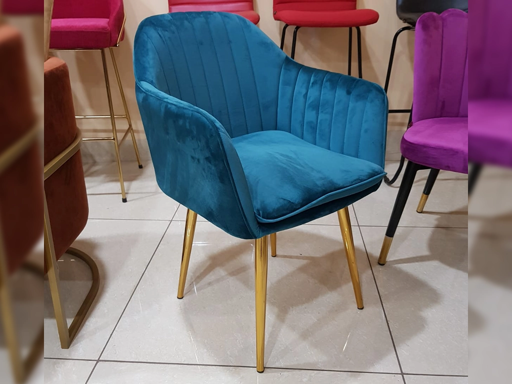 Teal color Chair With velvet upholstered back and seat line stitched in back and hand rest , metal gold PVD electroplated finish legs.