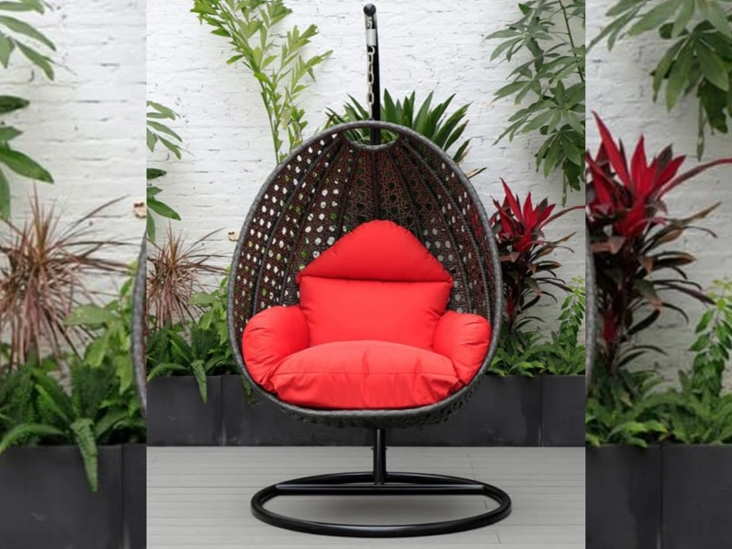 grey color single seater swing chair star design with red color cushion for rooftop area.