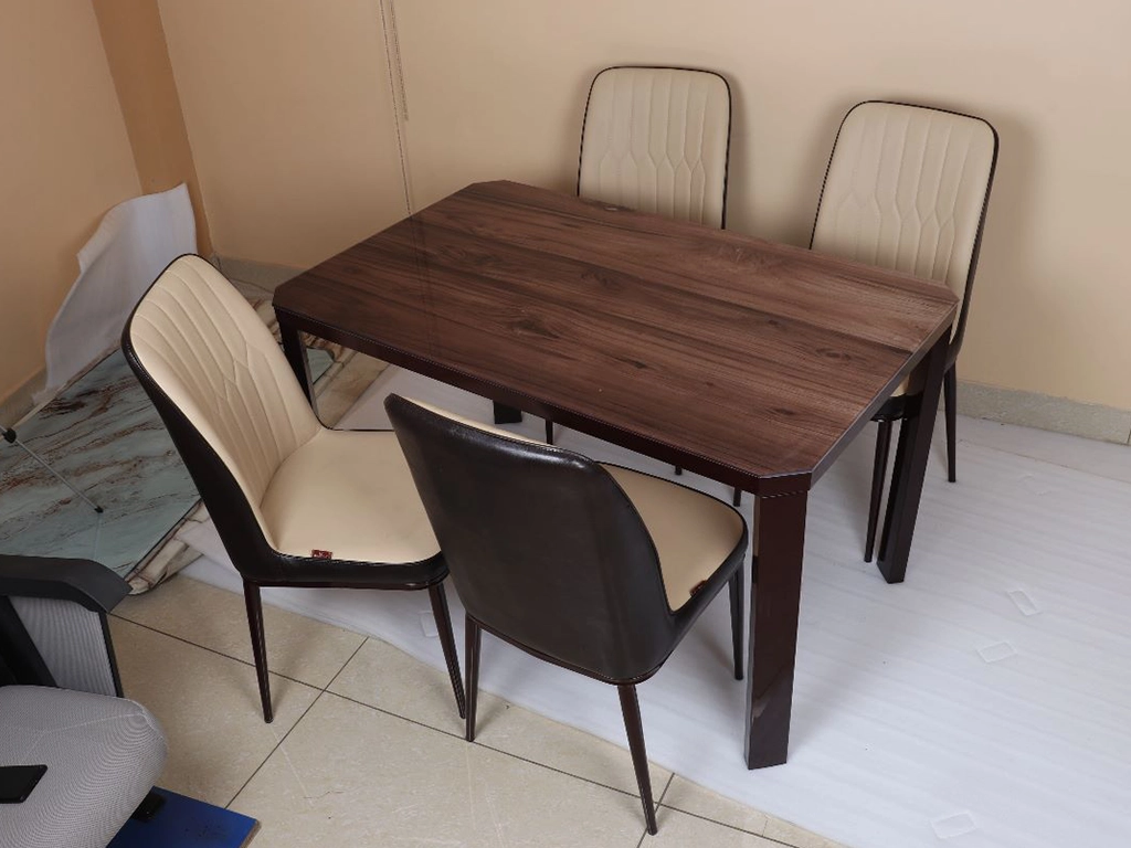 Four pcs dinning chair with rectangular table. chair beige & brown color upholstered with leatherette, metal powder coated with gold cap legs. Table metal base with brown color powder coated finish, table top-textured with engineer wood finish.