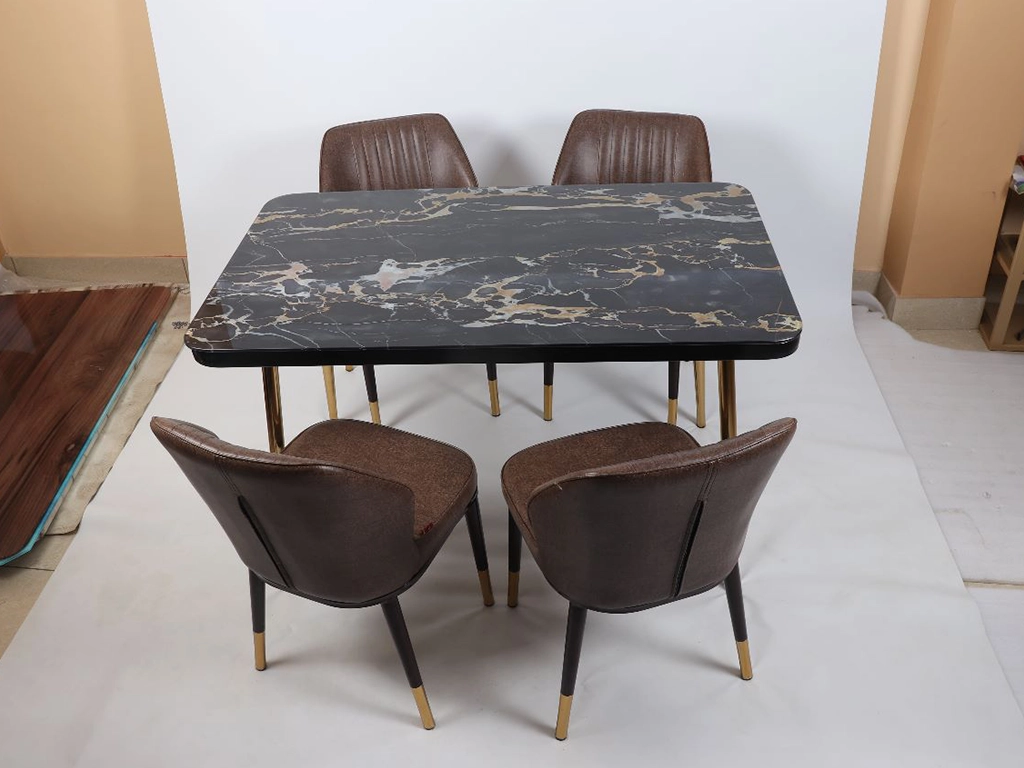 Four pcs dinning chair with rectangular table. chair brown color upholstered with leatherette, metal powder coated with gold cap legs. Table metal base with PVD electroplated finish, top textured engineer wood finish.