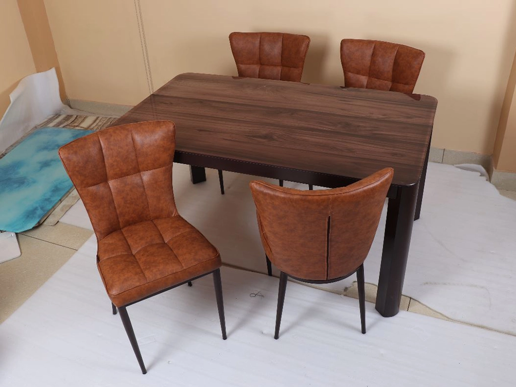 Four pcs dinning chair with rectangular table. chair textured tan color upholstered with leatherette, metal powder coated legs. Table metal base with brown color powder coated finish. table top textured with engineer wood finish.